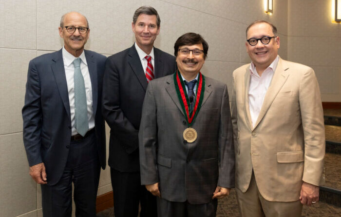 From left, David H. Perlmutter, MD, George and Carol Bauer Dean of the School of Medicine; Nupam Mahajan, PhD; John A. Olson Jr., MD, PhD, head of the Department of Surgery; and Chancellor Andrew J. Martin.