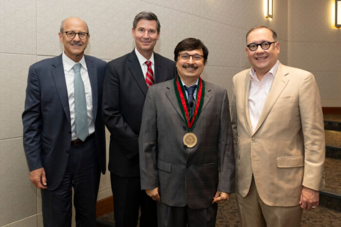 From left, David H. Perlmutter, MD, George and Carol Bauer Dean of the School of Medicine; Nupam Mahajan, PhD; John A. Olson Jr., MD, PhD, head of the Department of Surgery; and Chancellor Andrew J. Martin.